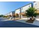 Back exterior view of townhomes featuring wooden balconies and driveways with attached garages at 3057 Windover Ln, Kennesaw, GA 30144