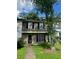 Two-story townhouse with neutral siding, black shutters, a well-kept lawn, and mature shade trees at 8564 Jamestown Way, Jonesboro, GA 30238
