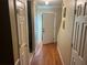 View of the hallway with wood flooring and white doors in the home at 8564 Jamestown Way, Jonesboro, GA 30238