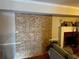 Living room with hardwood floors and brick fireplace with drywall at 8564 Jamestown Way, Jonesboro, GA 30238