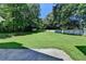 Large backyard with healthy green grass and trees at 969 Bob Hannah Cir, Lawrenceville, GA 30044