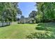 Green backyard showing the house with a wood privacy fence and mature trees at 969 Bob Hannah Cir, Lawrenceville, GA 30044