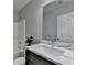 Bathroom featuring a white sink with gray cabinets and a tub/shower combination at 969 Bob Hannah Cir, Lawrenceville, GA 30044