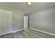 Bedroom featuring gray walls, wood-look flooring, and two doors at 969 Bob Hannah Cir, Lawrenceville, GA 30044
