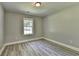 Bedroom with gray walls, a window, light fixture and wood-look flooring at 969 Bob Hannah Cir, Lawrenceville, GA 30044