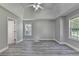 Spacious bedroom with tray ceilings, ceiling fan, vinyl plank flooring, and two windows at 969 Bob Hannah Cir, Lawrenceville, GA 30044