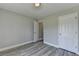 Bedroom featuring gray walls, wood-look flooring, and a white door at 969 Bob Hannah Cir, Lawrenceville, GA 30044