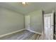 Bedroom featuring gray walls, wood-look flooring, and a white door at 969 Bob Hannah Cir, Lawrenceville, GA 30044