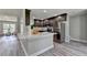 Modern kitchen with dark cabinets, stainless steel appliances, quartz counters and open floor plan to the living room at 969 Bob Hannah Cir, Lawrenceville, GA 30044