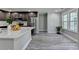 Bright kitchen with stainless steel appliances, dark cabinetry, quartz countertops, and light gray wood flooring at 969 Bob Hannah Cir, Lawrenceville, GA 30044