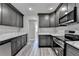 Modern gray kitchen with stainless steel appliances, quartz countertops and new gray wood flooring at 969 Bob Hannah Cir, Lawrenceville, GA 30044