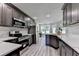 Modern kitchen with gray cabinets, stainless appliances, white countertops and gray vinyl plank flooring at 969 Bob Hannah Cir, Lawrenceville, GA 30044