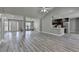 Spacious living room with a view of the entry, kitchen, and grey wood floors with lots of natural light at 969 Bob Hannah Cir, Lawrenceville, GA 30044