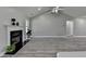 Cozy living room with a fireplace, light gray walls and a view of the backyard at 969 Bob Hannah Cir, Lawrenceville, GA 30044