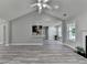 Open-concept living room with vaulted ceiling, modern gray walls, light wood flooring and a glimpse into the kitchen at 969 Bob Hannah Cir, Lawrenceville, GA 30044