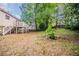 Backyard features a deck and house view, mature trees, offering outdoor entertaining and relaxation at 1060 Heatherwood Ct, Norcross, GA 30093