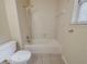 A simple bathroom design showcases a tub and shower combo with tile surround at 1060 Heatherwood Ct, Norcross, GA 30093