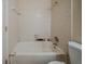 Modest bathroom features tile walls, a bathtub with shower, and a toilet for essential functionality at 1060 Heatherwood Ct, Norcross, GA 30093