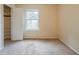 Neutral bedroom featuring a standard closet, window, and neutral walls and carpet at 1060 Heatherwood Ct, Norcross, GA 30093