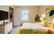Stylish bedroom features a vibrant yellow bed, soft lighting, and ample storage for a comfortable and modern living space at 1060 Heatherwood Ct, Norcross, GA 30093