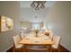 Inviting dining area with modern chandelier and hardwood floors, blending seamlessly into the bright and open living space at 1060 Heatherwood Ct, Norcross, GA 30093