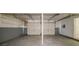 Spacious garage with two white doors, concrete floors, and ample room for parking and storage at 1060 Heatherwood Ct, Norcross, GA 30093