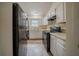 Functional kitchen featuring white cabinets and modern black appliances at 1060 Heatherwood Ct, Norcross, GA 30093