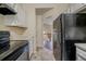 Practical kitchen featuring white cabinets, and neutral flooring at 1060 Heatherwood Ct, Norcross, GA 30093