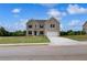 New construction two-story home with brick facade, dark shutters, manicured lawn and two-car garage at 111 Felicity Pike, Locust Grove, GA 30248