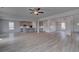 Open-concept living area with view of the kitchen, featuring hardwood floors and stylish design at 111 Felicity Pike, Locust Grove, GA 30248
