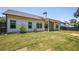 Spacious backyard with green grass, flower beds, and covered patio at 2124 Bullock Bluff Dr, Loganville, GA 30052