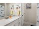 Bright bathroom with vanity, white cabinets and shower with curtain at 2124 Bullock Bluff Dr, Loganville, GA 30052