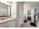 Bright bathroom with granite countertop, white cabinets, and glass shower doors at 2124 Bullock Bluff Dr, Loganville, GA 30052