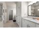 Bright bathroom featuring a granite countertop, white cabinets, and walk-in shower at 2124 Bullock Bluff Dr, Loganville, GA 30052