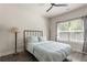 Bedroom with stylish decor, ceiling fan, and bright window at 2124 Bullock Bluff Dr, Loganville, GA 30052