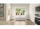 Bright breakfast nook with laminate flooring, a view to the backyard, and stainless steel microwave at 2124 Bullock Bluff Dr, Loganville, GA 30052