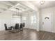 Elegant dining room with a coffered ceiling, decorative lighting, and hardwood floors at 2124 Bullock Bluff Dr, Loganville, GA 30052