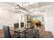 Open-concept dining room with decorative lighting, hardwood floors and easy access to the kitchen and living room at 2124 Bullock Bluff Dr, Loganville, GA 30052