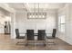 Dining room features hardwood floors, wainscotting, and modern light fixture at 2124 Bullock Bluff Dr, Loganville, GA 30052