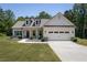 Charming single-Gathering home with a two-car garage and meticulously manicured front yard at 2124 Bullock Bluff Dr, Loganville, GA 30052