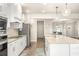 Bright kitchen featuring white cabinetry, stainless steel appliances, and ample counter space at 2124 Bullock Bluff Dr, Loganville, GA 30052