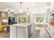 Open-concept kitchen with large island, stainless steel appliances and a view to the breakfast nook and living area at 2124 Bullock Bluff Dr, Loganville, GA 30052