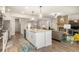 Modern kitchen with stainless steel appliances and an island with a sink and granite countertops at 2124 Bullock Bluff Dr, Loganville, GA 30052