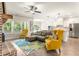 Open concept living room featuring hardwood floors, brick fireplace, and seamless access to kitchen at 2124 Bullock Bluff Dr, Loganville, GA 30052