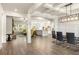 Open floor plan with coffered ceilings and hardwood floors seamlessly connects living room to kitchen at 2124 Bullock Bluff Dr, Loganville, GA 30052