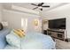 Tranquil main bedroom with tray ceilings, hardwood floors, and windows providing plenty of natural light at 2124 Bullock Bluff Dr, Loganville, GA 30052