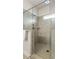 Close up of walk-in shower with gray tiles and glass surround at 2124 Bullock Bluff Dr, Loganville, GA 30052