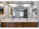 Bathroom featuring a double vanity, two mirrors, many lights, and a bathtub and shower in the background at 2368 Glynn Se Dr, Atlanta, GA 30316