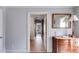 Hallway featuring carpet, neutral colored walls, a window, and a wooden dresser with mirror at 2368 Glynn Se Dr, Atlanta, GA 30316