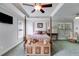 Spacious bedroom with a four-poster bed, sitting area, and a coffered ceiling with a ceiling fan at 2368 Glynn Se Dr, Atlanta, GA 30316